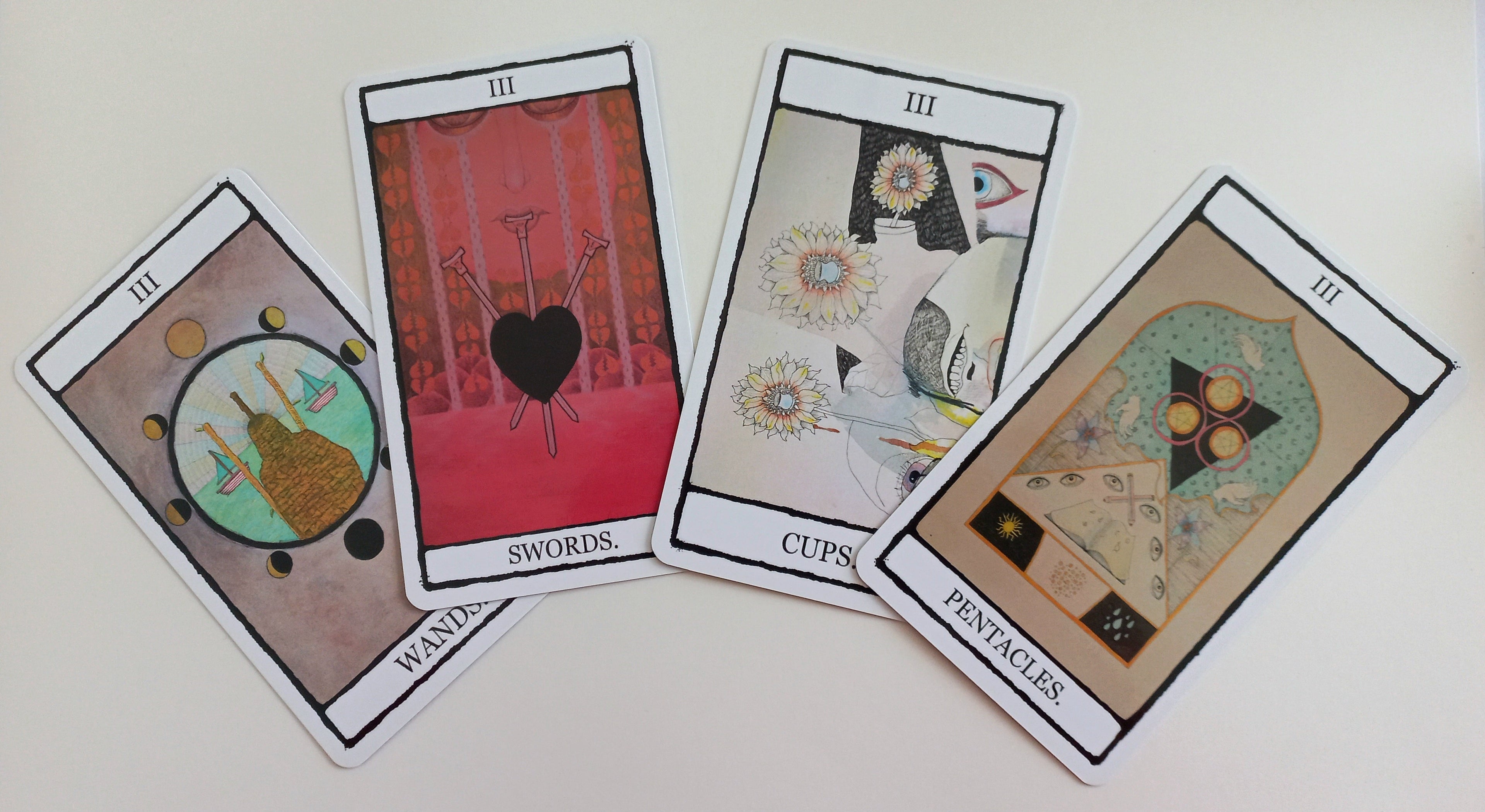 Four illustrated tarot cards from the Minor Arcana featuring the number three. 
