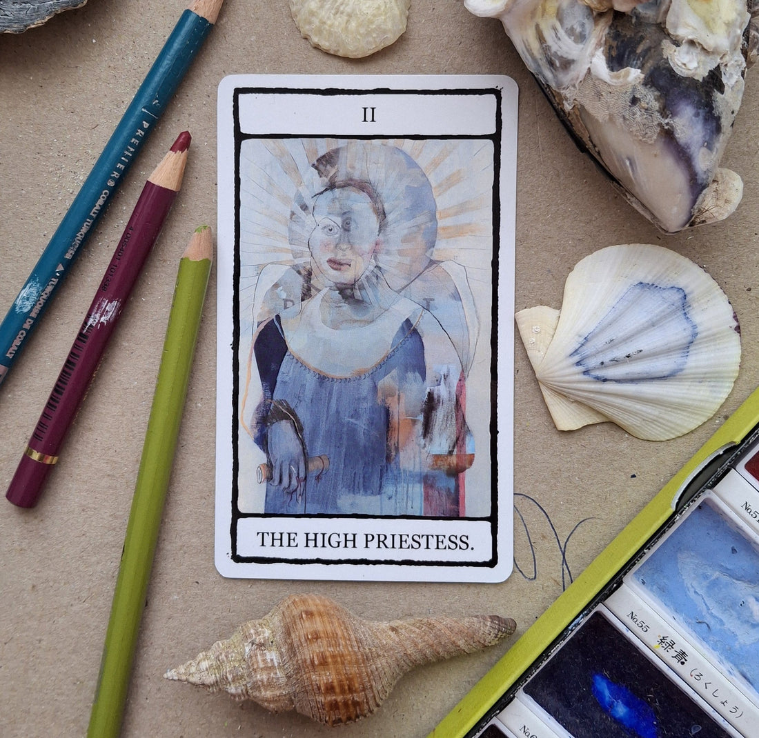 The High Priestess tarot card from The Falling Card Tarot, a hand illustrated card featuring a blue double exposure style portrait of a woman.