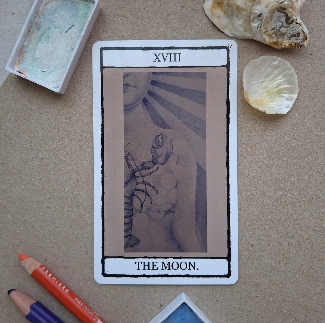 Hand illustrated image of The Moon tarfot card from The falling Card Tarot featuring a blue surreal woman with a lobster covering her torso. 