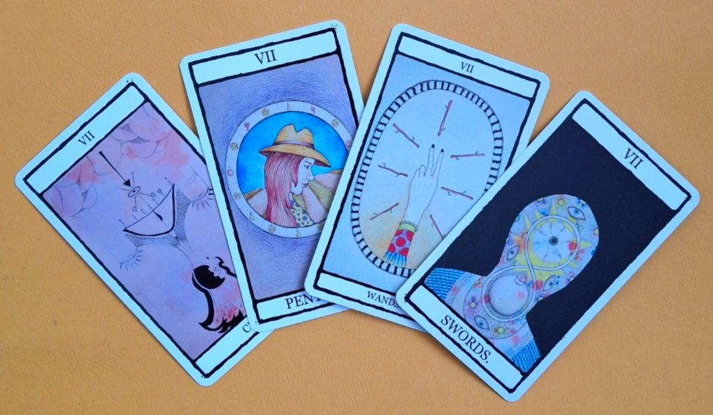 Four tarot cards from the Minor Arcana Sevens: Seven of Wands, Seven of Cups, Seven of Swords, and Seven of Pentacles