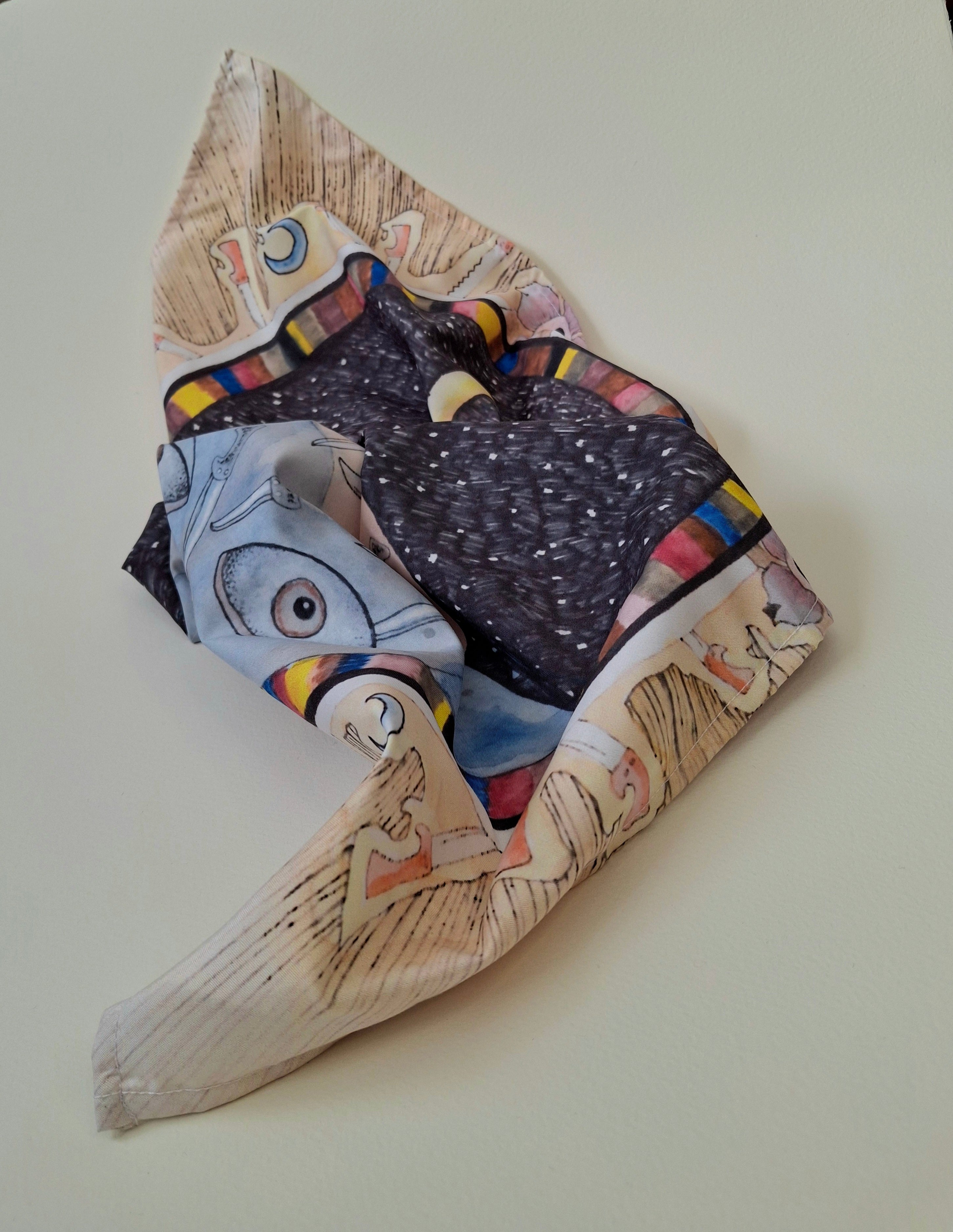 Folded tarot wrap with dark illustration print on a light background