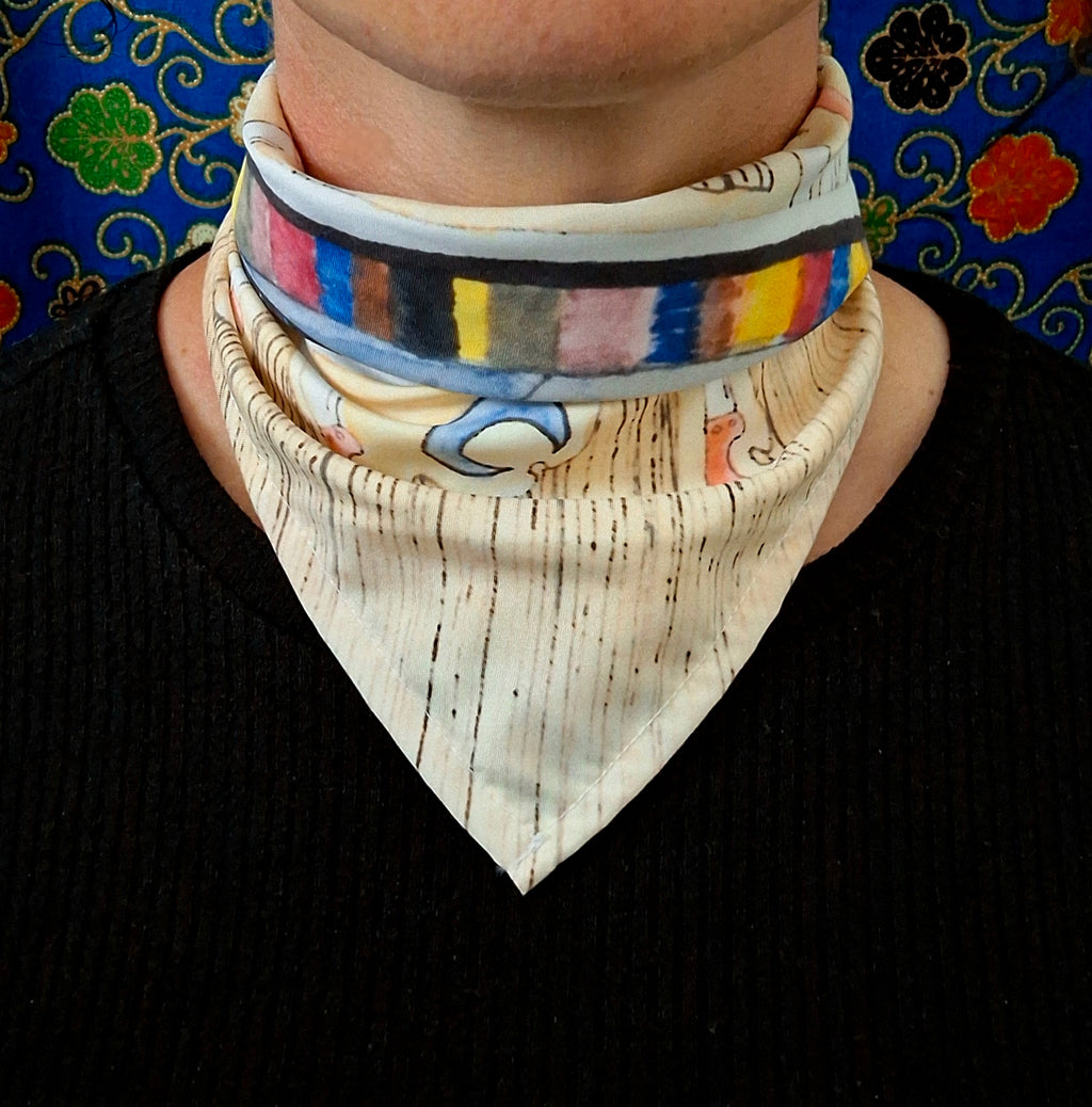 Person wearing a colourful printed scarf in front of a blue background