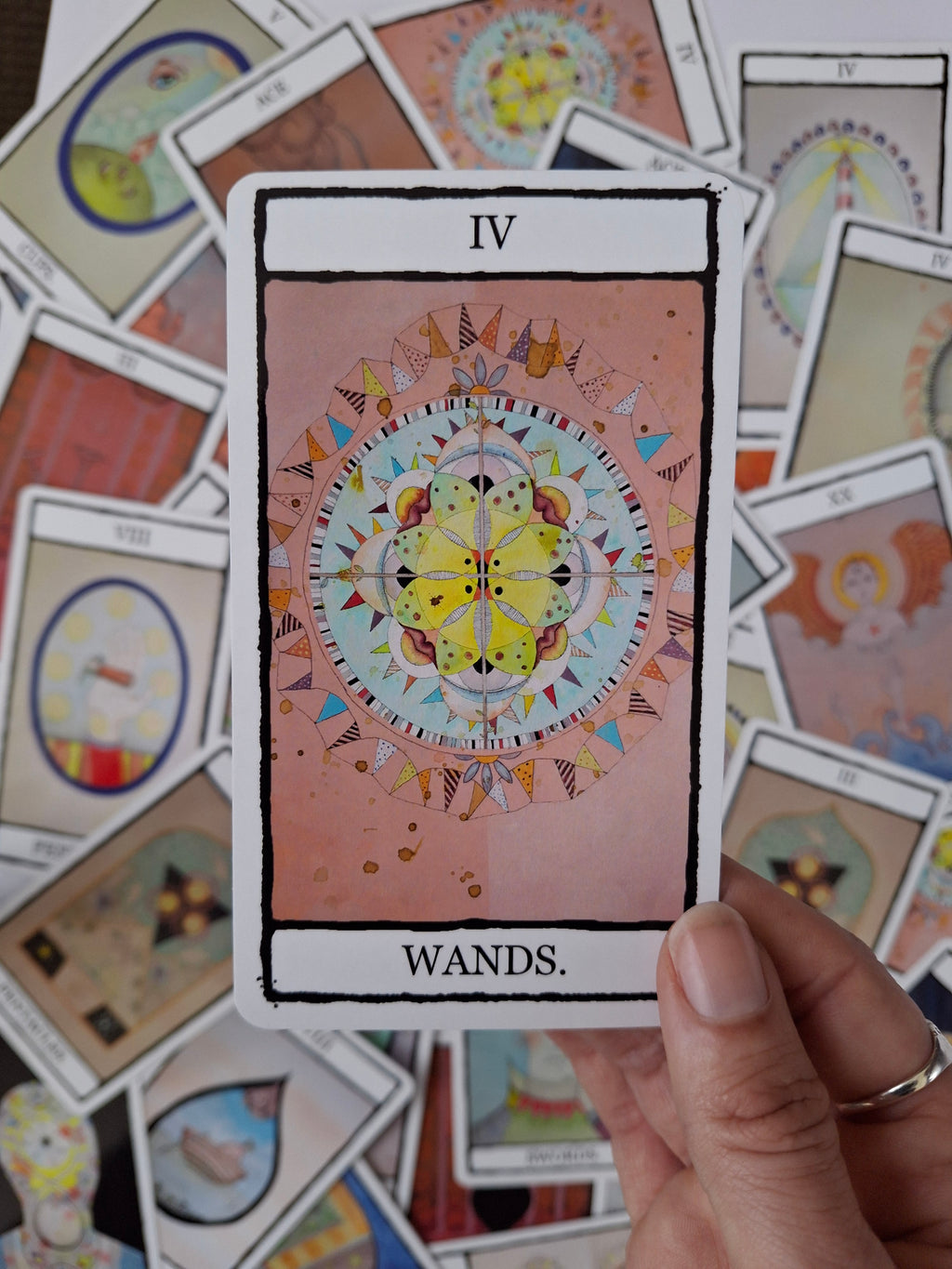 4 of Wands tarot card with hand painted illustration of a colourful kaleidoscope with eyes, lips and flags