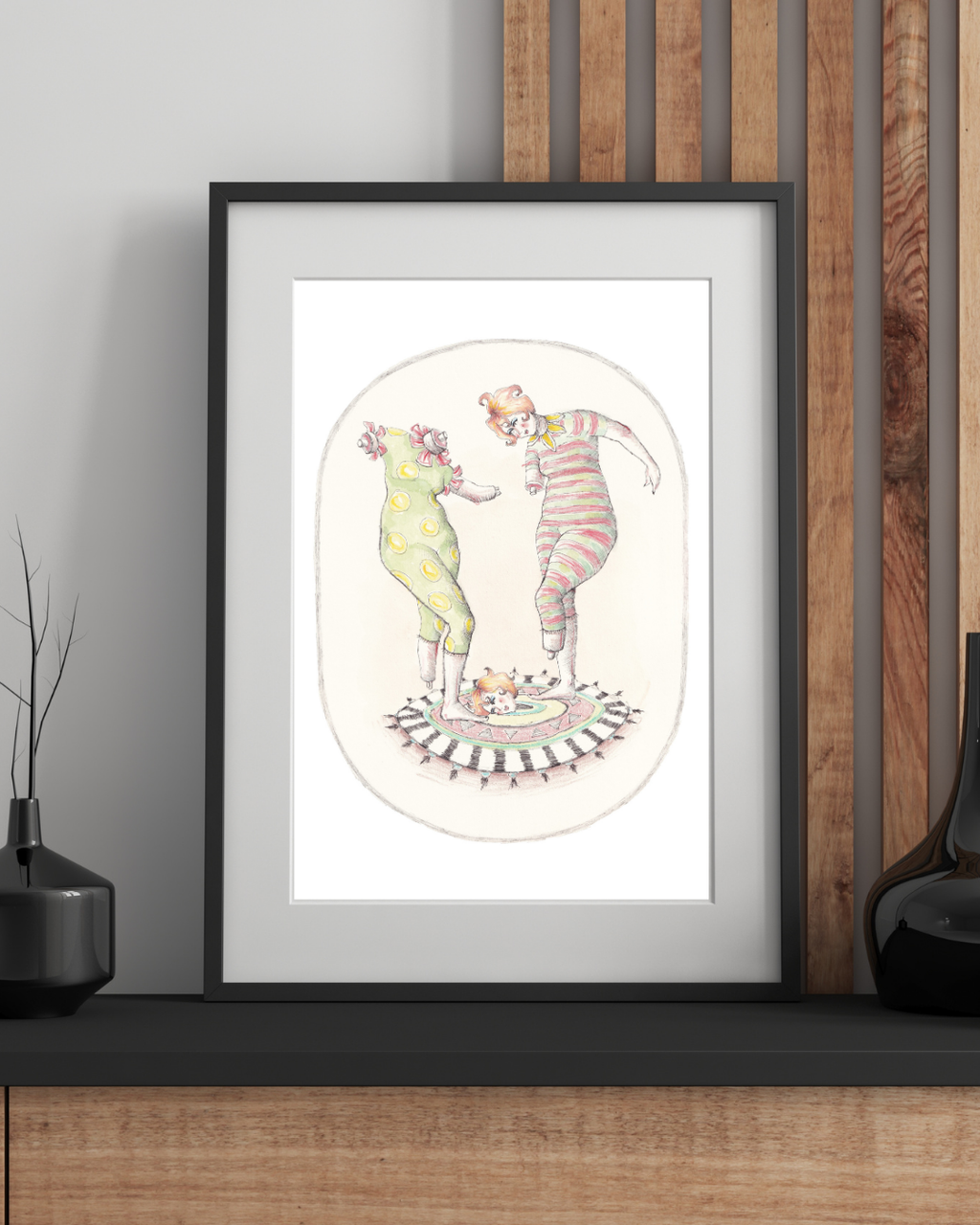 Dancing figures art print displayed in natural wood frame on neutral wall, A4 A3 size reference