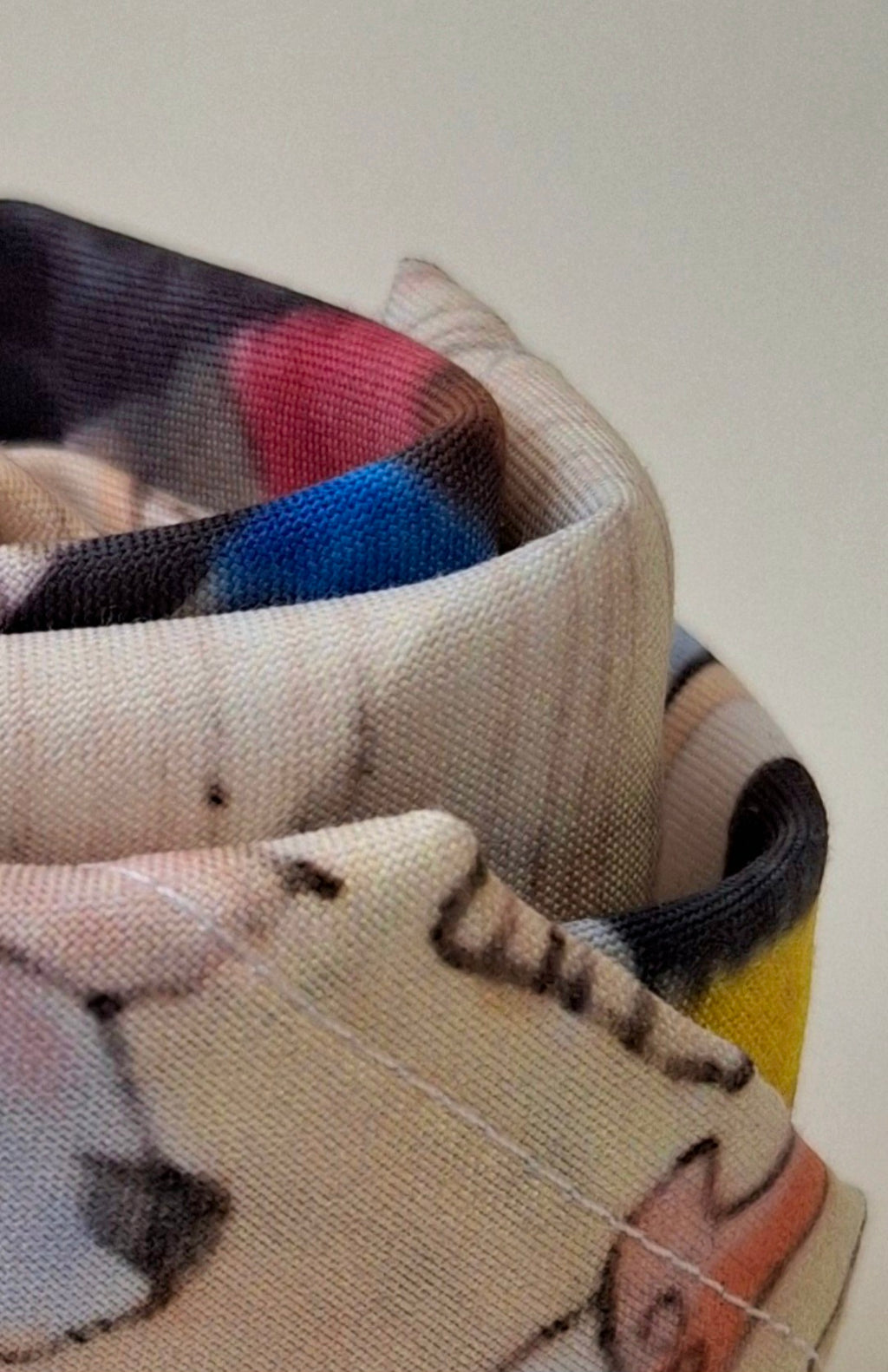 Close-up of a colorful altar cloth with patterns and textures on a plain background